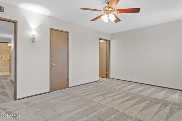 unfurnished bedroom with baseboards, visible vents, a ceiling fan, and light colored carpet