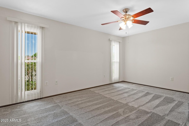 unfurnished room with baseboards, a ceiling fan, and carpet flooring
