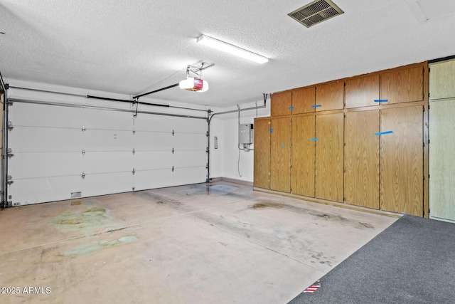 garage featuring a garage door opener and visible vents