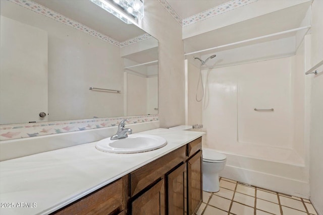 full bathroom featuring toilet, tile patterned flooring,  shower combination, and vanity