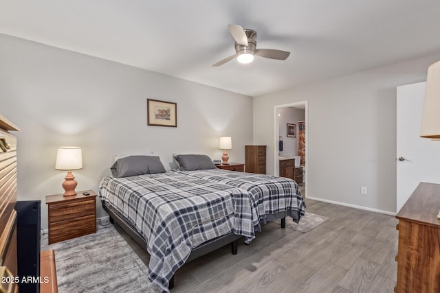 bedroom featuring ceiling fan, ensuite bathroom, and light wood-type flooring