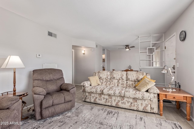 living room featuring wood-type flooring and ceiling fan