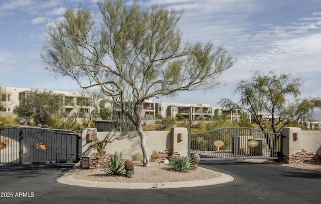 view of gate with a residential view and fence