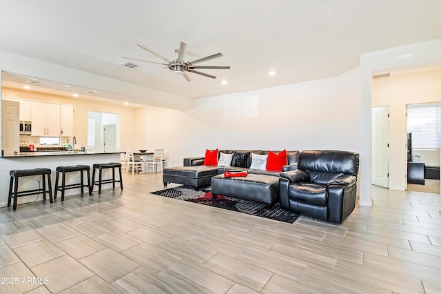 living room with recessed lighting, visible vents, and ceiling fan