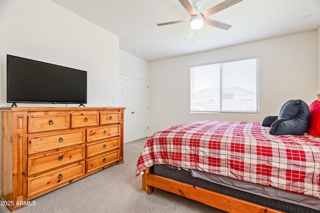 bedroom featuring light colored carpet and ceiling fan