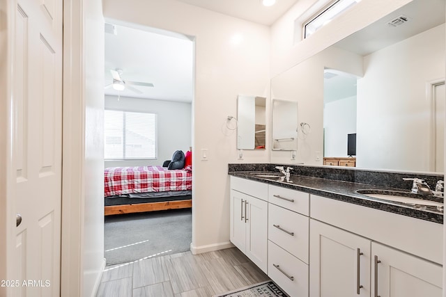 bathroom featuring visible vents, a ceiling fan, a sink, connected bathroom, and double vanity