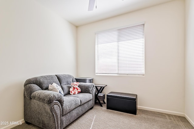 sitting room with baseboards, ceiling fan, and carpet flooring