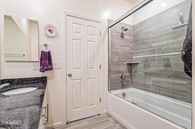 bathroom with vanity and shower / bath combination with glass door