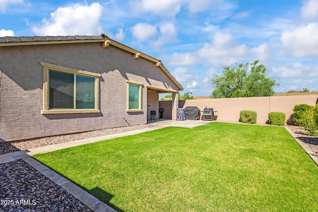 back of house featuring a patio, fence, a lawn, and stucco siding