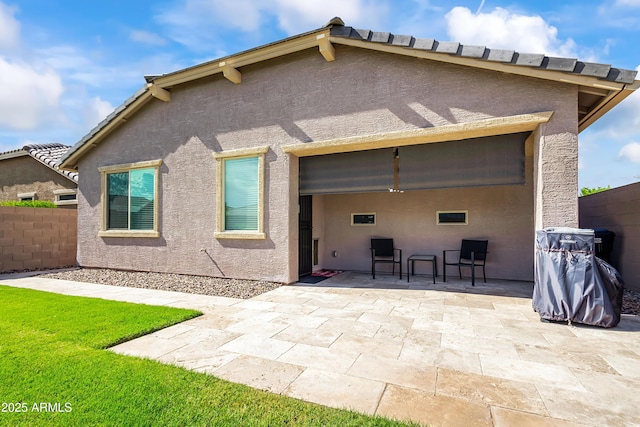 back of house featuring a patio area, stucco siding, and fence