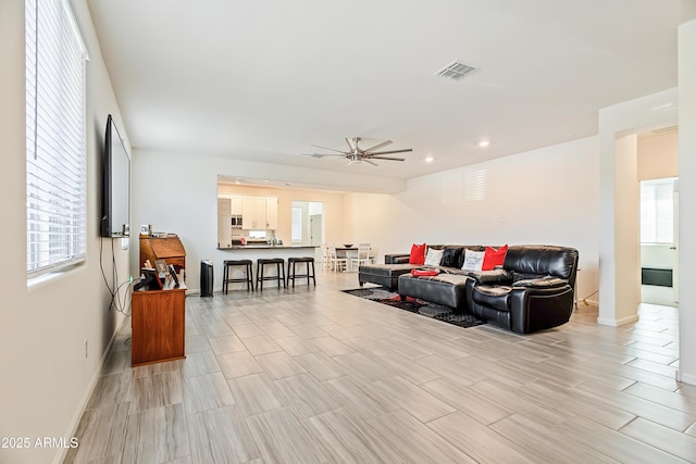 living area featuring wood finish floors, visible vents, a ceiling fan, recessed lighting, and baseboards