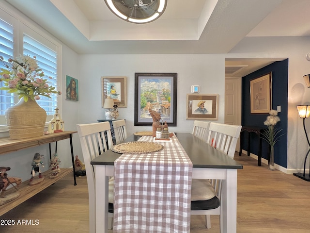 4554 E Paradise Village Pkwy N Unit 133, Phoenix, AZ 85032 - dining room featuring light wood finished floors and a raised ceiling