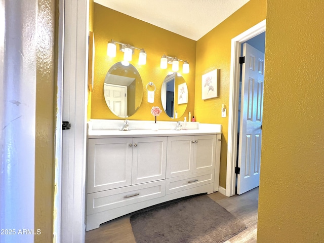 4554 E Paradise Village Pkwy N Unit 133, Phoenix, AZ 85032 - full bath with double vanity, wood finished floors, and a textured wall