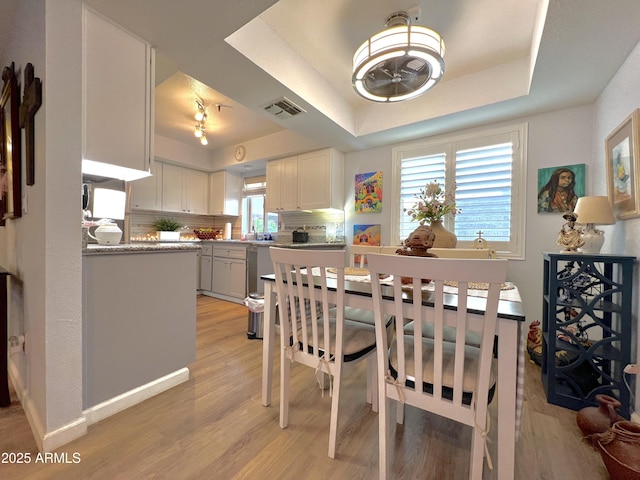 4554 E Paradise Village Pkwy N Unit 133, Phoenix, AZ 85032 - dining area with a raised ceiling and light wood finished floors