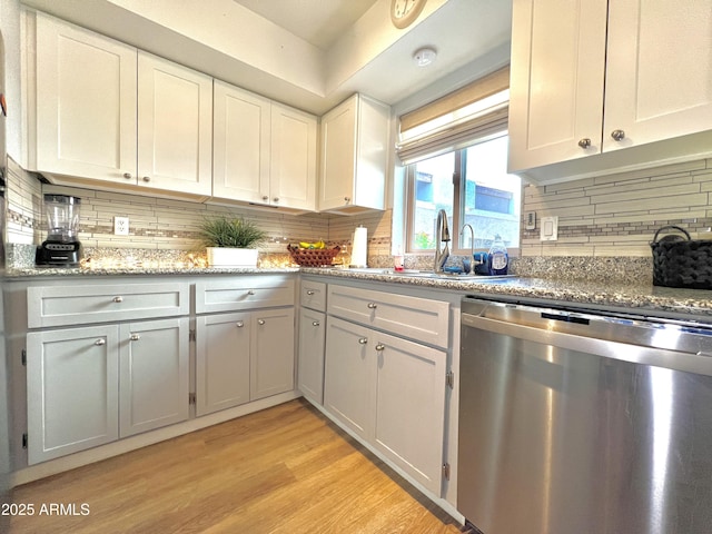 4554 E Paradise Village Pkwy N Unit 133, Phoenix, AZ 85032 - kitchen featuring stainless steel dishwasher, backsplash, light wood-style flooring, white cabinets, and light stone counters