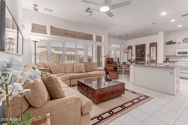 living room with visible vents, recessed lighting, ceiling fan, and light tile patterned floors
