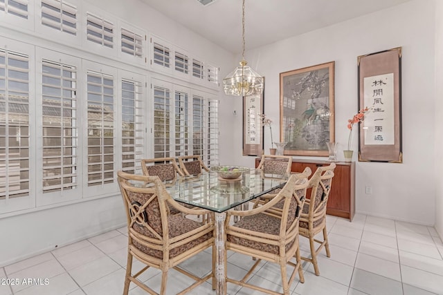 dining room with light tile patterned floors and a notable chandelier