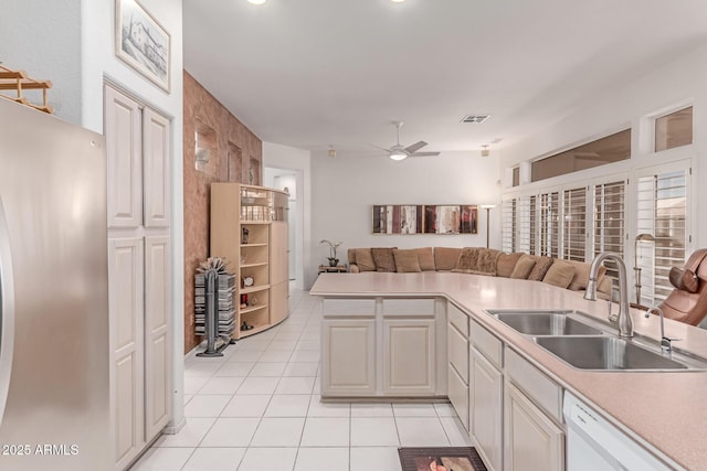 kitchen with ceiling fan, visible vents, dishwasher, a sink, and freestanding refrigerator