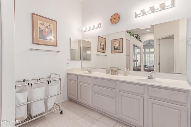 ensuite bathroom featuring double vanity, ensuite bathroom, a sink, and tile patterned flooring