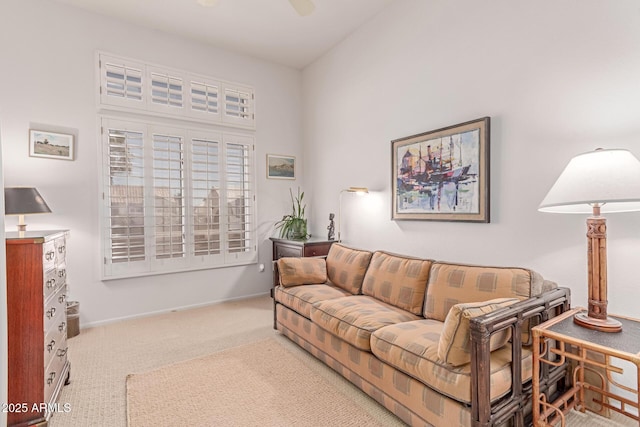 living area featuring baseboards and carpet flooring