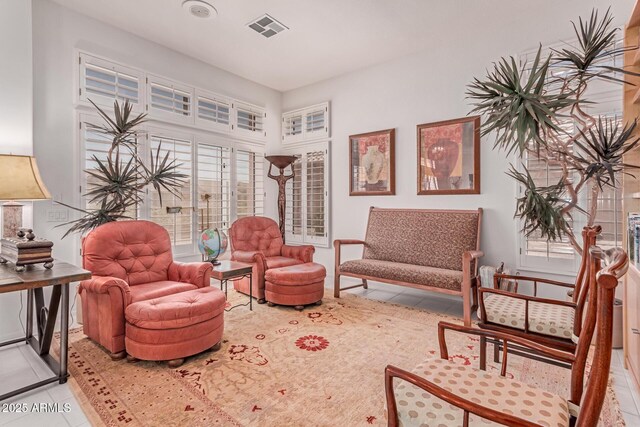 sitting room featuring light tile patterned flooring and visible vents
