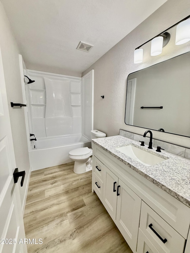 3014 W Zachary Dr, Phoenix, AZ 85027 - full bath featuring vanity, wood finished floors, tub / shower combination, a textured ceiling, and a textured wall