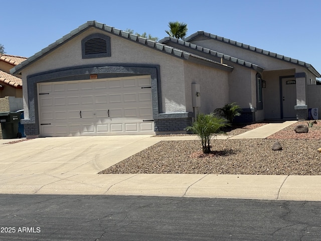 3014 W Zachary Dr, Phoenix, AZ 85027 - view of front of home featuring a garage, driveway, stucco siding, and a tiled roof