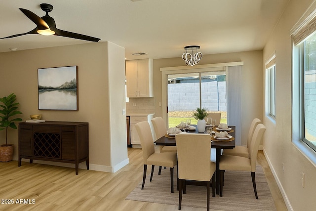 3014 W Zachary Dr, Phoenix, AZ 85027 - dining area featuring light wood-style floors, a ceiling fan, and a chandelier