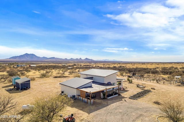 birds eye view of property with a mountain view