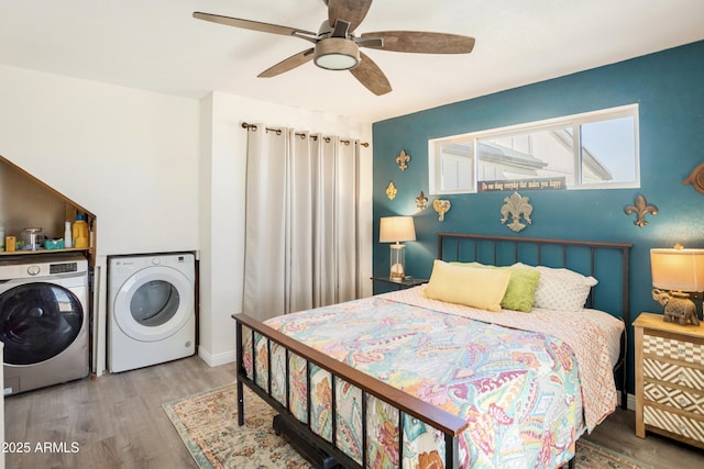 bedroom with ceiling fan, washer and dryer, and wood-type flooring