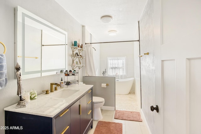 bathroom with toilet, vanity, tile patterned floors, and a bathtub