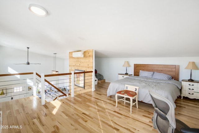 bedroom featuring light wood-type flooring and lofted ceiling