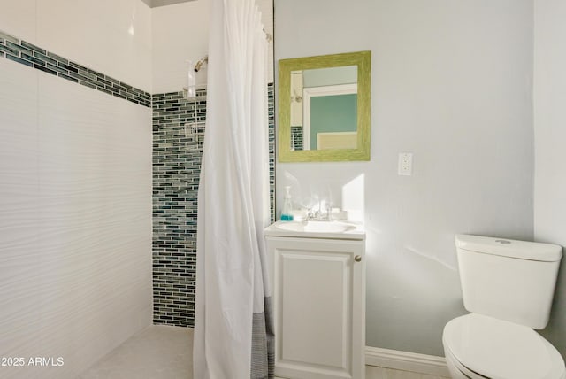 bathroom featuring vanity, curtained shower, and toilet