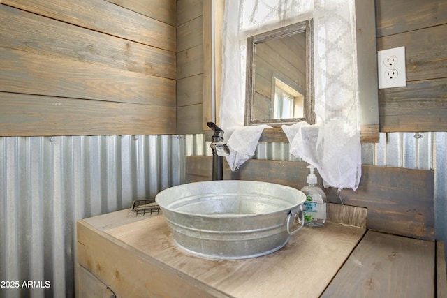 bathroom featuring wood walls