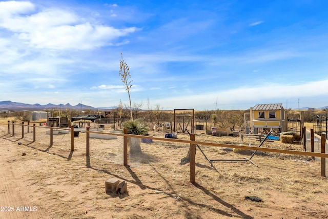 view of play area with a mountain view and a rural view