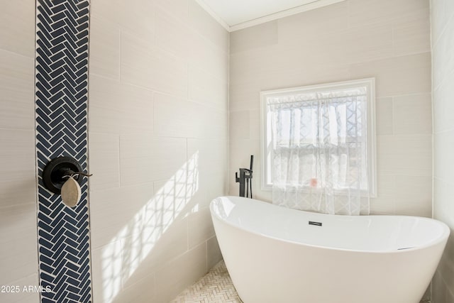 bathroom with a tub and tile walls