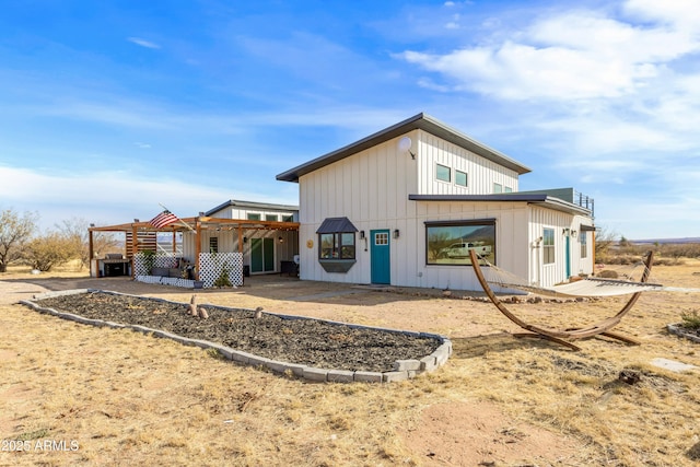 rear view of house featuring a pergola and a patio