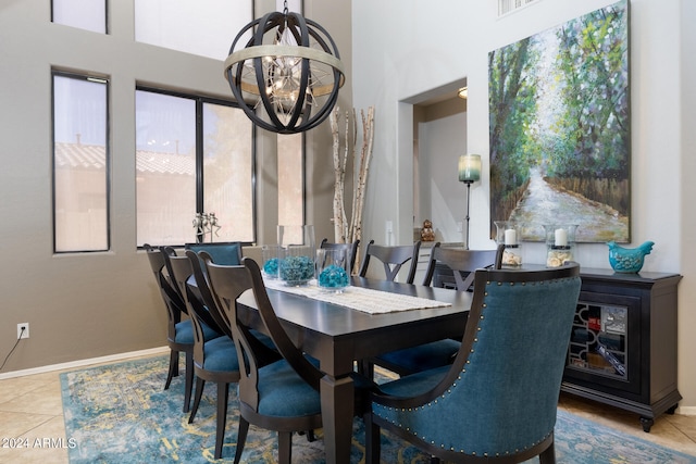 tiled dining space with a chandelier