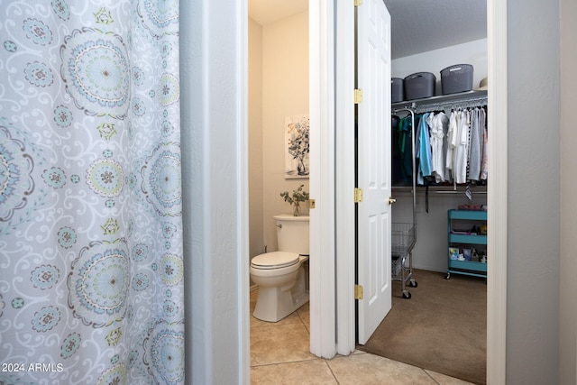 bathroom featuring tile patterned flooring and toilet