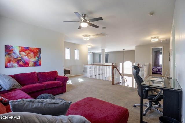 carpeted living room with ceiling fan