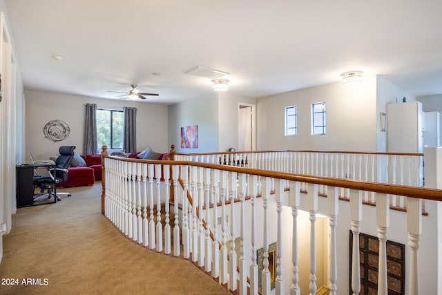 hallway featuring light colored carpet