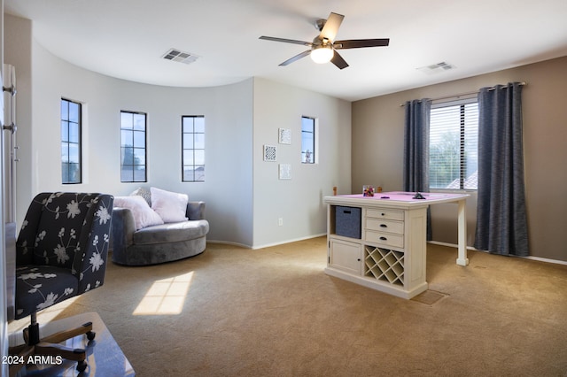 interior space featuring ceiling fan and light colored carpet