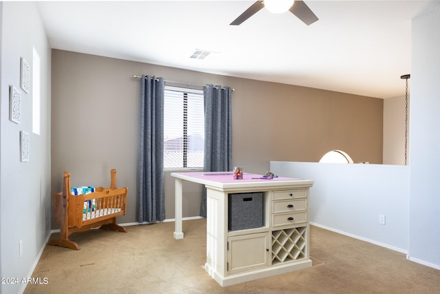 playroom with ceiling fan and light colored carpet