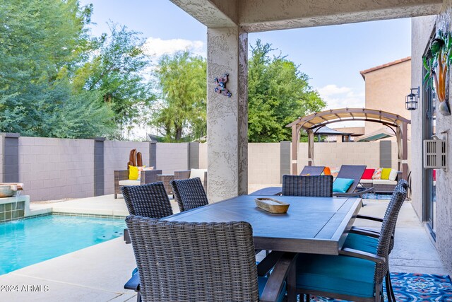 view of patio / terrace featuring pool water feature, a fenced in pool, and outdoor lounge area