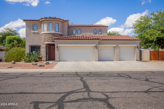 mediterranean / spanish-style home featuring a garage