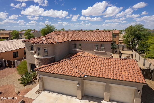 mediterranean / spanish-style home with a garage