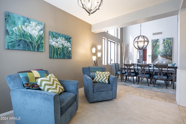 living room with light tile patterned floors and a notable chandelier