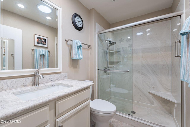 bathroom with vanity, toilet, and walk in shower