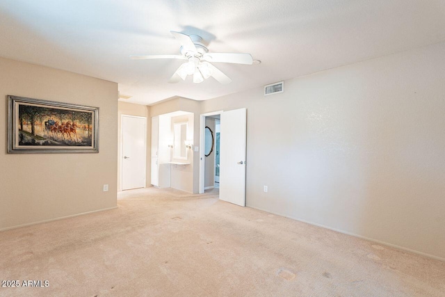 spare room with light colored carpet and ceiling fan