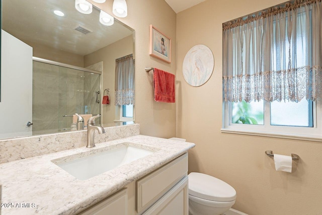 bathroom with vanity, toilet, and walk in shower